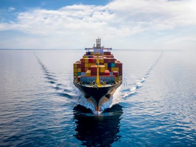 Aerial,Front,View,Of,A,Loaded,Container,Cargo,Vessel,Traveling
